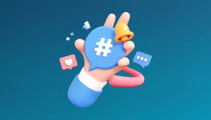Ilustração de uma mão segurando um ícone de hashtag, cercado por ícones de curtidas e balões de diálogo, simbolizando o uso de hashtags para aumentar a interação no Instagram.