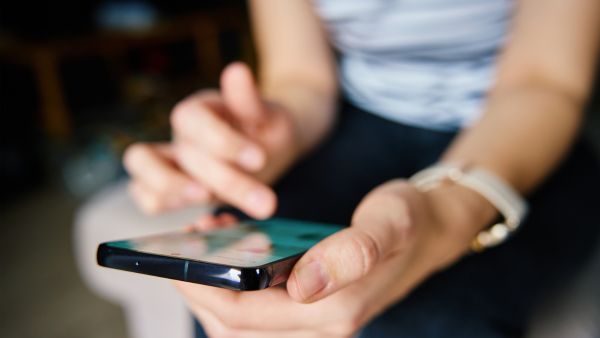 Mulher buscando ideias de nomes para Instagram feminino no celular