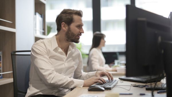 Profissional escrevendo texto de apresentação de empresa para clientes no escritório